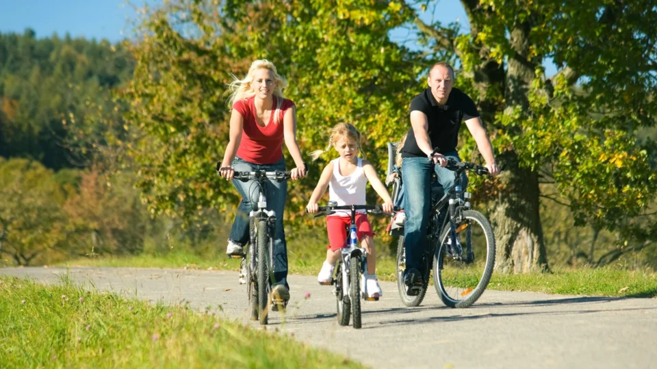 Family enjoying a scenic cycling path surrounded by lush greenery near the hotel, perfect for outdoor adventures.