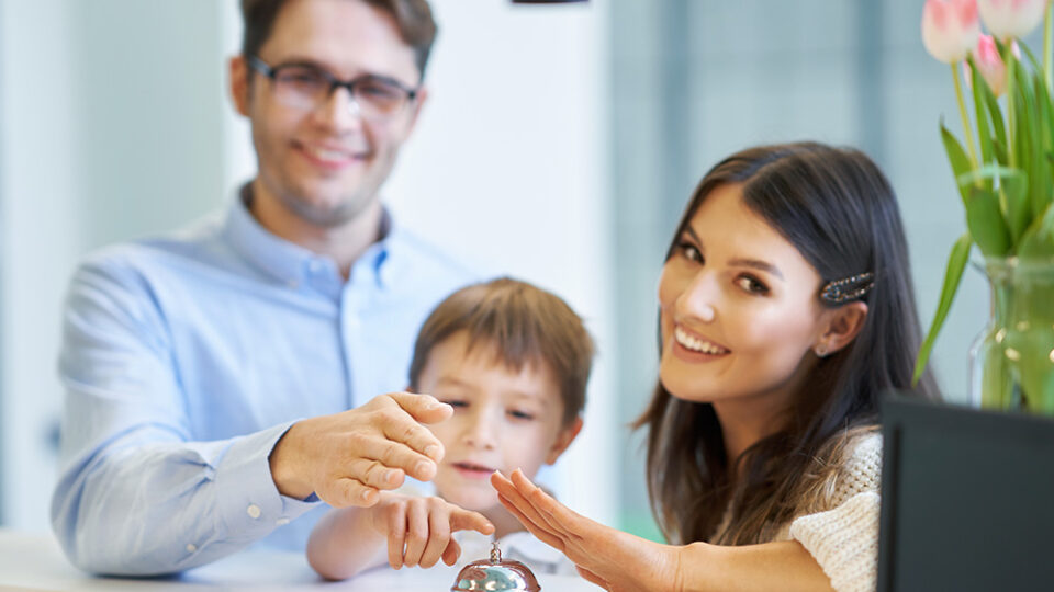 picture-of-family-checking-in-hotel