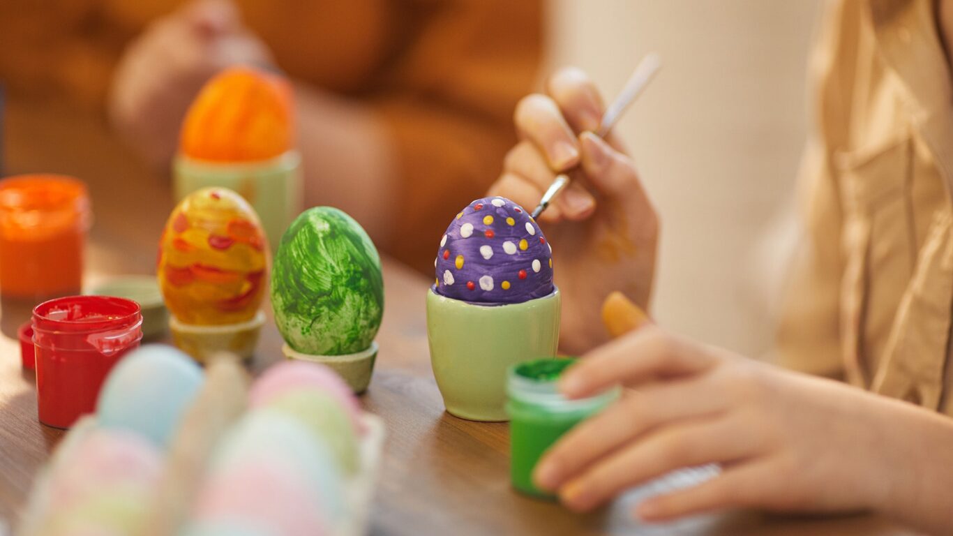 child-decorating-easter-eggs-min
