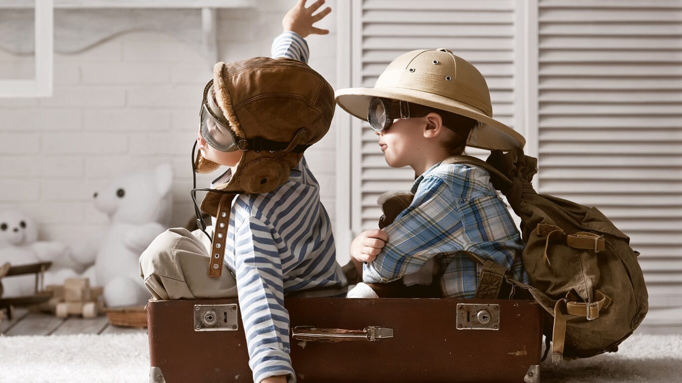 2 boys on suitcase-banner-min