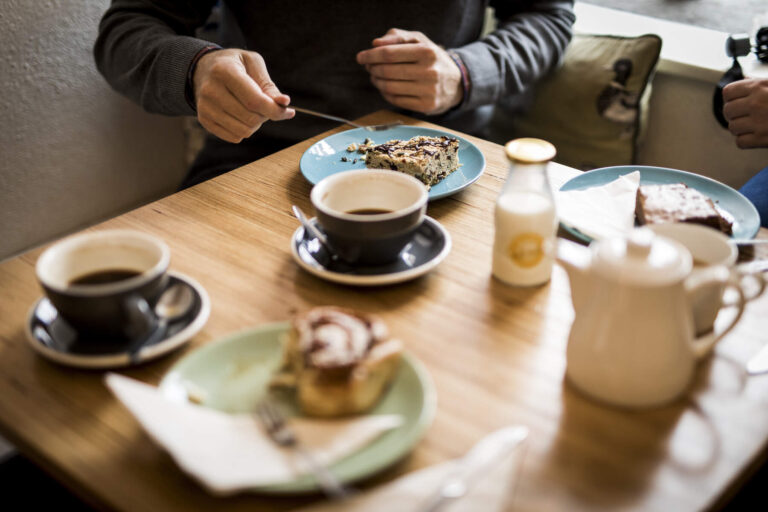 Visitors to the Killarney, drinking coffee, chatting and smiling