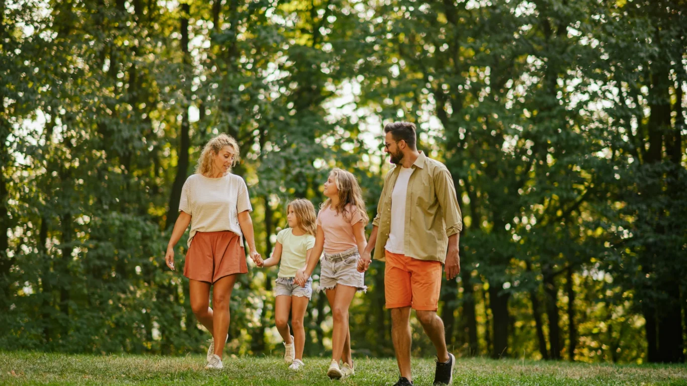 Family enjoying a walk in lush, scenic woodland, perfect for relaxing getaways and outdoor adventures.