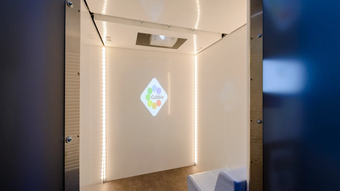 Modern sensory relaxation pod with soft seating and LED lighting for calm moments at the hotel.